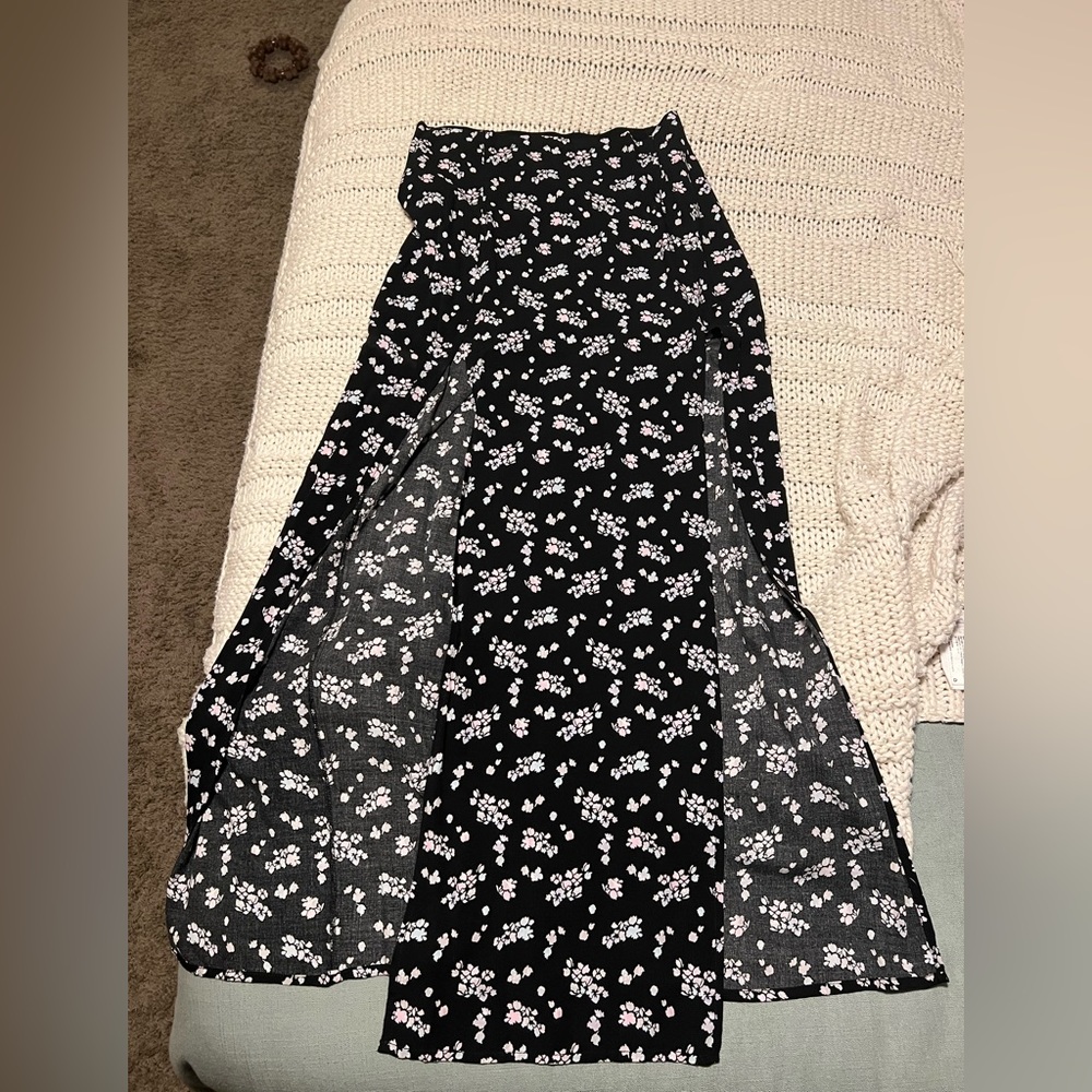 Garage black skirt with floral print and slit on both legs.